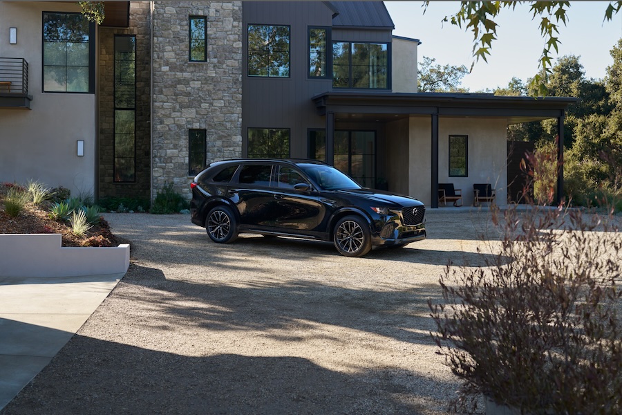 Mazda C-70 parked in front of a nice home.